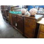 A reproduction mahogany breakfront bookcase with pullout slide