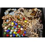 Tray of costume jewellery to include silver charm bracelet, contemporary necklace beads etc