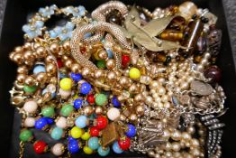 Tray of costume jewellery to include silver charm bracelet, contemporary necklace beads etc