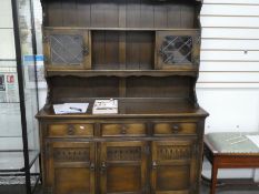 A reproduction oak draw leaf Dining table and set of six red leather Dining chairs and Kitchen dress