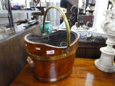 An antique oak and brass bound bucket having a swing handle