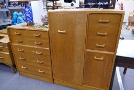 A vintage G-Plan chest having five long drawers, a similar compactum and a corner cupboard with desk