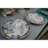 A pair of oriental plates, probably Japanese decorated figures in landscape 21.5cm