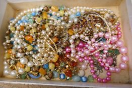 A small tray of costume jewellery, mostly bead necklaces