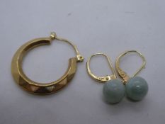 A Pair of 14ct earrings with a hung green hardstone beads and a single 9ct gold loop earring