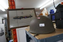 Vintage Army helmet together with mirror depicting No. 617 Squadron RAF