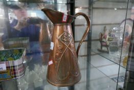 An Art Nouveau copper jug