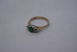 Pretty 9ct yellow gold dress ring set with central green stone, flanked 3 diamonds either side, mark