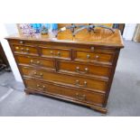 A reproduction mahogany chest having seven drawers with brushing slide, 105cm