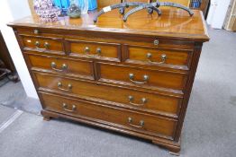 A reproduction mahogany chest having seven drawers with brushing slide, 105cm