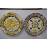 A pair of Continental possibly 19th Century chargers, with yellow and blue glaze, one decorated drag