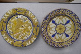 A pair of Continental possibly 19th Century chargers, with yellow and blue glaze, one decorated drag