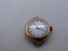 Antique, 9ct yellow gold watch marked 375 with white enamel dial, winds and ticks, 13.2g gross appro