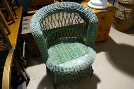 A green painted cane armchair and a metal bound pine trunk