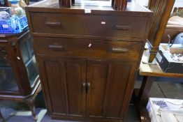 A 1930's oak cupboard with two drawers