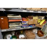 Shelf of various items including records, board games, train accessories, castle chess set etc