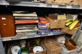 Shelf of various items including records, board games, train accessories, castle chess set etc