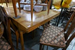 Mid century teak extending dining table and a set of six chairs By Nathan