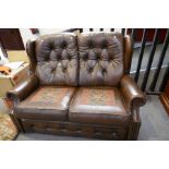 A modern brown leather 2 seat settee, having button back, 146cm