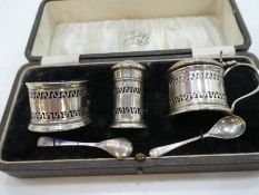 A silver cruet set of pierced design and Bristol blue inserts. Hallmarked Birmingham 1930, Docker &