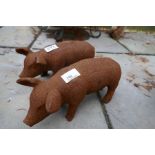 Two small cast iron pigs