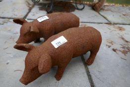 Two small cast iron pigs