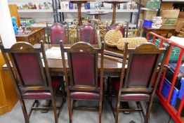 A reproduction Oak draw leaf refectory table with a set of 6 oak dining chairs, the table extended 2