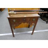 An antique oak low boy having three drawers on square chamfered legs