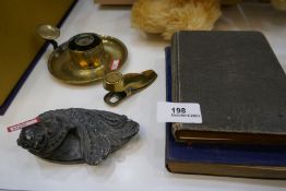 A Victorian brass paper clip in the form of a shoe, an antique brass candlestick and sundry