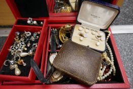 Red jewellery box containing earrings, watches, bead necklaces, cased 'Harrods' pearl cufflink set,