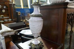 A Victorian lamp having Parian band decorated cherubs with gilt metal mounts