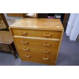 A vintage G-Plan oak chest of four drawers and a similar dressing table on splay legs