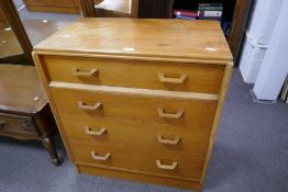 A vintage G-Plan oak chest of four drawers and a similar dressing table on splay legs