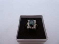 Contemporary 18ct yellow gold emerald cut tourmaline ring surrounded by diamond chips, Size O/P, 5.6