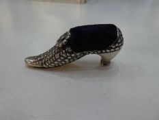 A silver novelty shoe pin cushion of ornate, decorative design, with moving flower. Nice