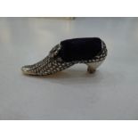 A silver novelty shoe pin cushion of ornate, decorative design, with moving flower. Nice