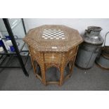 A Moorish octagonal table on folding base, with floral bone inlaid decoration and chess board top, 5