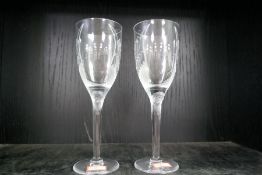 A pair of Lalique wine glasses decorated winged angel