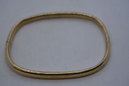 9ct yellow gold bangle of square form, marked 9K, dent at hinge, 6.5cm diameter 7.2g approx marked 9