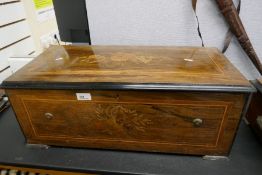 A Victorian Rosewood and inlaid music box having 10 Airs with bells and drum