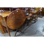 An antique mahogany tripod table