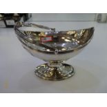 A Georgian Silver bon bon dish on a pedestal foot with a handle. Appears to be of very high quality.