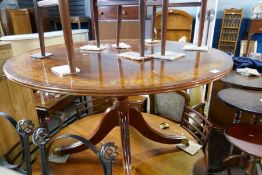 A circular reproduction dining table having painted decoration on quadropod base, by Restall Brown &