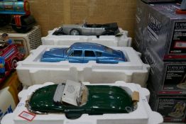 A selection of 1:24 scale Frankllin Mint precision model cars, including an E-Type