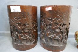 A pair of Chinese bamboo brush pots, carved figures in trees, 18.5cm