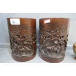 A pair of Chinese bamboo brush pots, carved figures in trees, 18.5cm