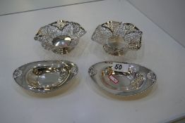 A pair of high quality, decorative silver bon bon dishes of pierced design on a raised pedestal foot