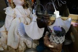 A box of mixed items including jewellery display, vintage resin figures, dolls and a costume Policem