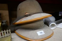Two vintage pith helmets, one stamped Leopard Brand
