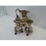 A pair of silver Asprey and Co Ltd peppers with gadrooned rim and lion feet. One lidded. Hallmarked